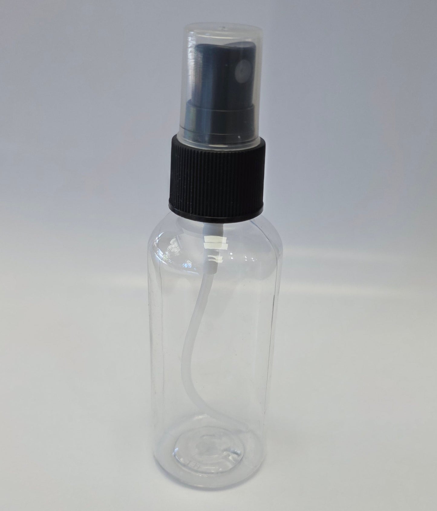 Clear plastic bottle with black cap on a white background