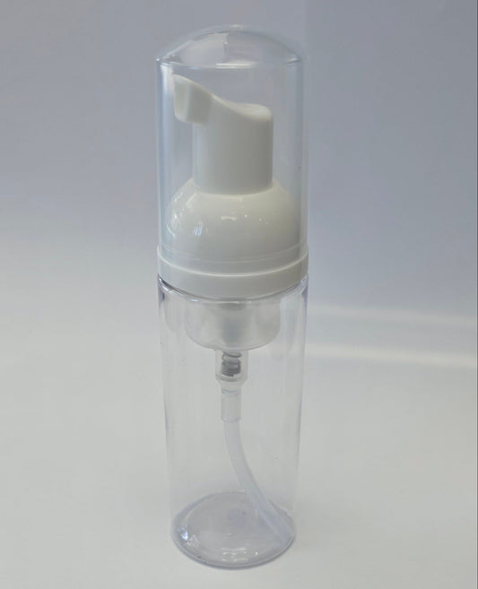 Clear plastic bottle with white foaming pump top on a white background